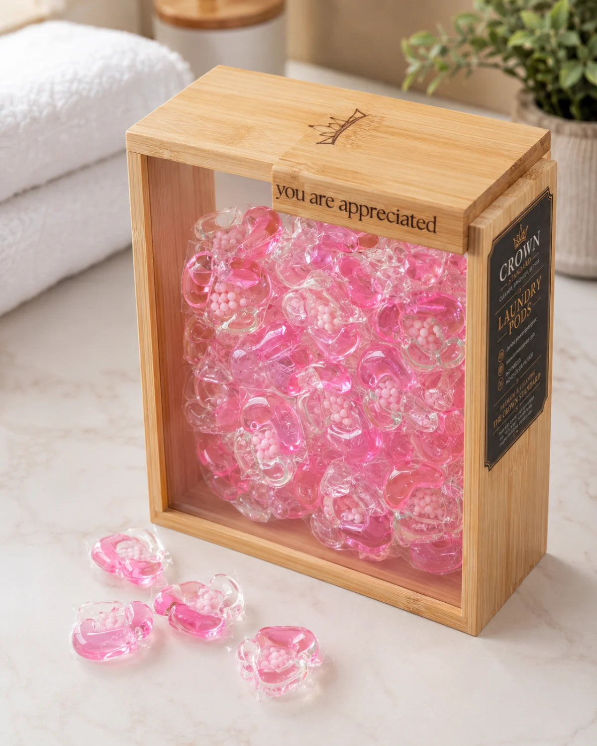 Crown Standard laundry pods displayed on a light stone bench