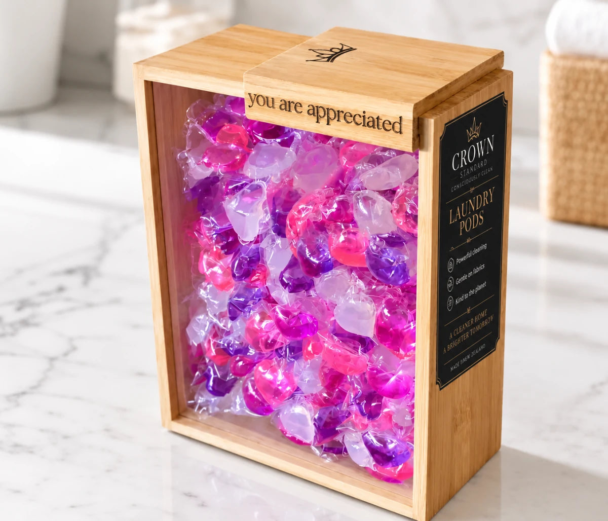 Crown Standard laundry pods displayed in the reusable bamboo container